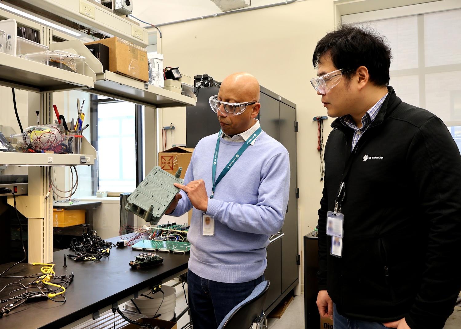 Two men in a lab looking at a piece of equipment